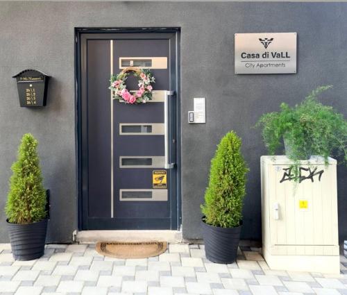 a front door of a building with two potted plants at Casa di VaLL in Ohrid