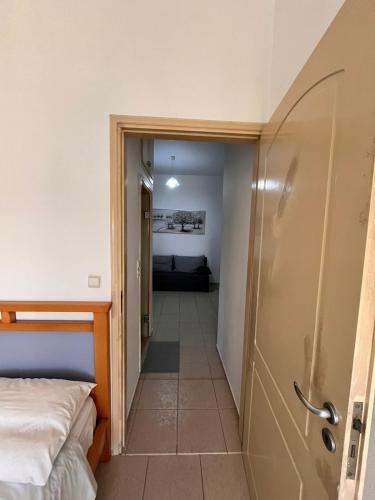 a hallway leading to a bedroom with a bed at Eirini Apts On the beach in Psari Forada