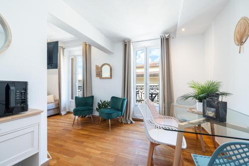 un salon avec une table en verre et des chaises dans l'établissement Massena Street - 1 Bdr Duplex with AC & Parking, à Nice