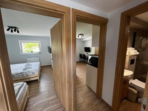 a small room with a bedroom and a bathroom at Apartament Wojska Polskiego 45 in Wadowice