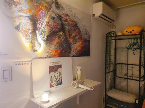 a bathroom with a painting on the wall at Light house hongdae Open sale in Seoul