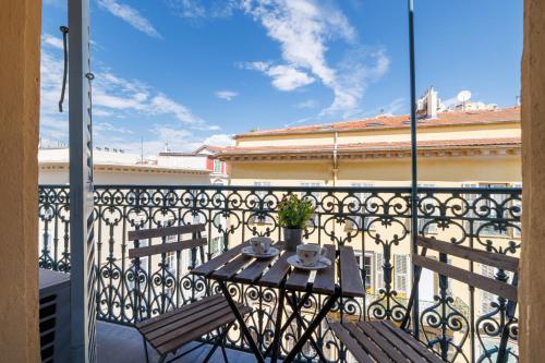 d'un balcon avec une table et deux chaises. dans l'établissement Massena Street - 1 Bdr Duplex with AC & Parking, à Nice