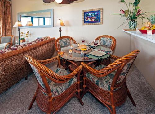 a dining room with a table and chairs at Kamahana 24 in Princeville