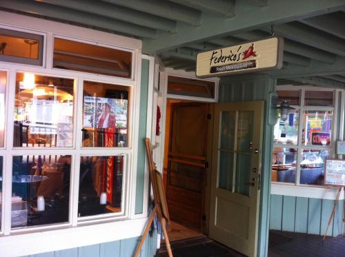 a front door of a restaurant with a sign on it at Kamahana 24 in Princeville