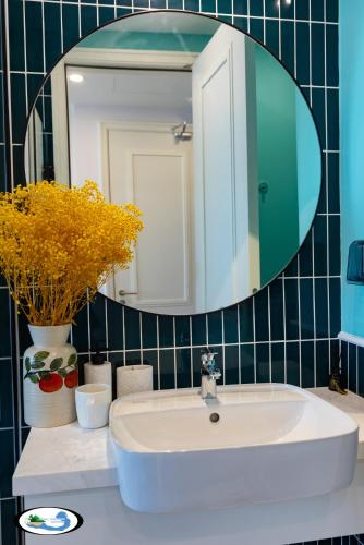 a bathroom with a sink and a mirror at Oscar Seaview Apartment in Phu Quoc