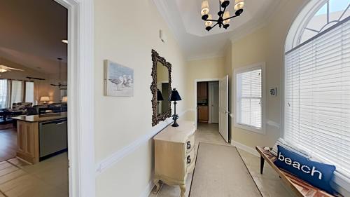 a living room with a table and a mirror at Coastal Escape at Greenhaven Inviting 4BR3BA Condo in Pawleys Island