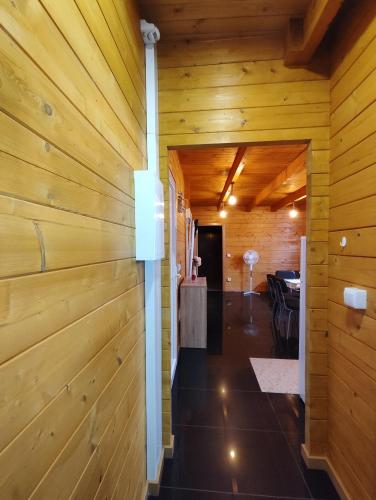 a hallway in a log cabin with wooden walls at Mondalva Guesthouse in São Pedro de Alva