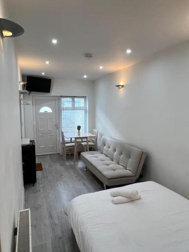 a bedroom with a bed and a couch and a table at Flat in Camden Kings Cross in London