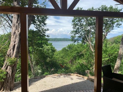 a screened in porch with a view of the water at Beach resort playa Leona in Gigantes