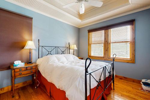 a bedroom with a bed and a window at Quittin' Time on the Woodside in Park City
