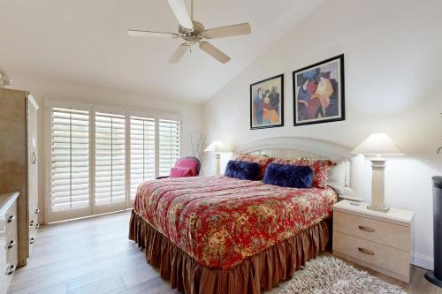 a bedroom with a bed and a ceiling fan at Riviera Manor Permit# 68147 in La Quinta