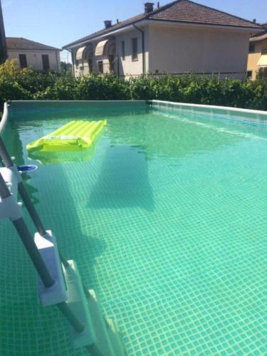 a swimming pool with two lounge chairs in the water at CasaGiarelli in Monti di Licciana Nardi