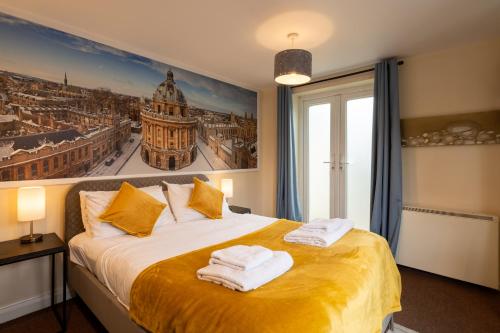 a bedroom with a bed with towels on it at Aryas Apartments Oxford - Headington in Oxford