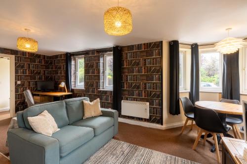 a living room with a couch and a table at Aryas Apartments Oxford - Headington in Oxford