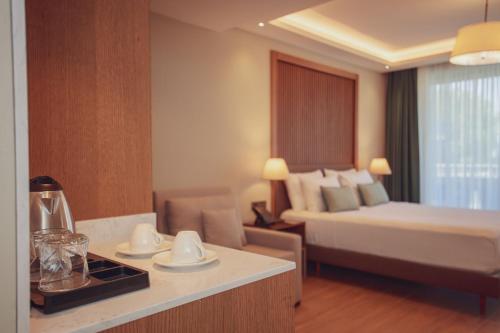 a hotel room with a bed and a kitchen with a table at Casa Lumar Luxury Lodging- Adult Only in Fethiye