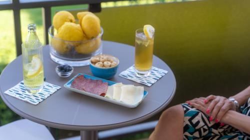 a table with a plate of food and drinks on it at Hotel Eden in Toscolano Maderno