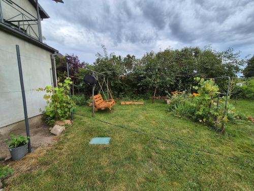 a garden with a swing in the grass at Pokoje Bema 14 in Ciechocinek