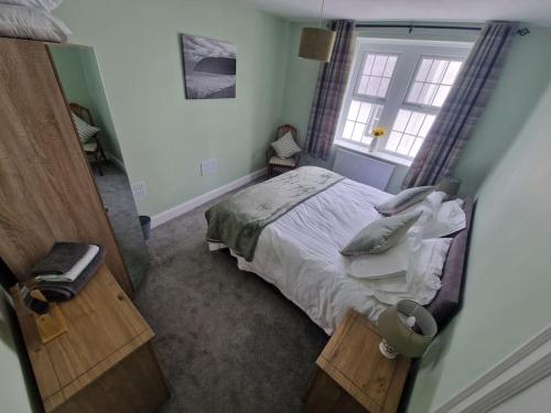 a bedroom with a bed and a window at The Old Bank at St Bees, Western Lakes in St Bees