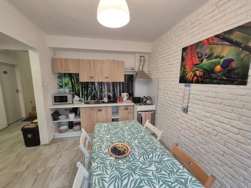 a kitchen with a table and a dining room at Pokoje Bema 14 in Ciechocinek