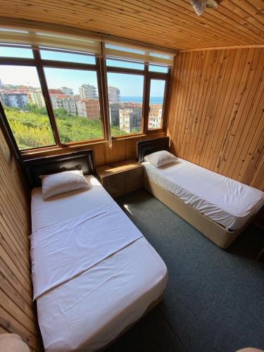 a room with two beds and a window at ST Apart in Pelitli