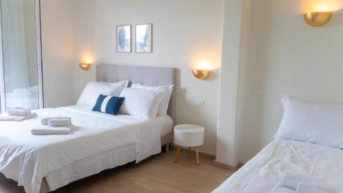 a bedroom with two beds and a mirror at Hotel Eden in Toscolano Maderno