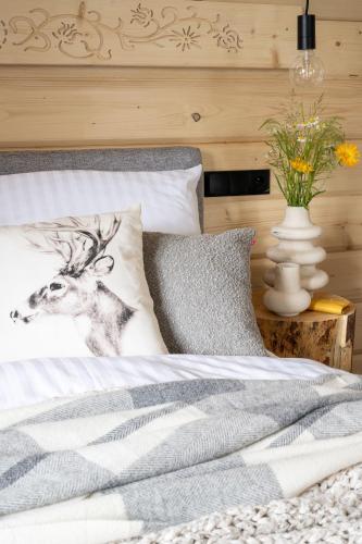 a bed with a picture of a deer on it at MiLove in Milówka