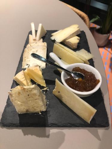 a plate of cheese and dipping sauce on a table at Villa Orsini - A Retreat in Pisa - Food and Relax in Pisa