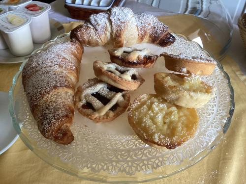 a glass plate with pastries on a table at Villa Orsini - A Retreat in Pisa - Food and Relax in Pisa