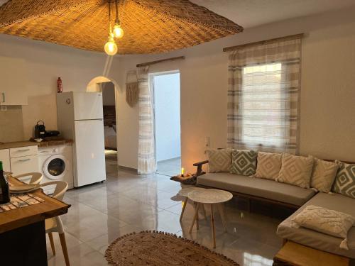a living room with a couch and a kitchen at Myth Experience Hercules in Agios Nikolaos