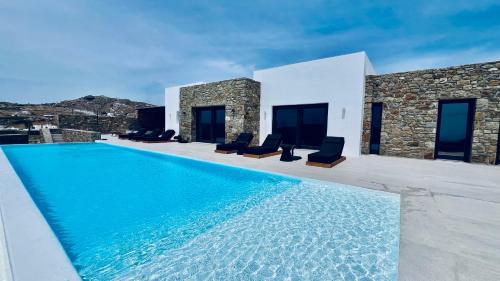 a swimming pool in front of a villa at Villa Taiyo Mykonos in Mikonos