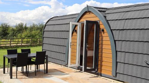 a circular shed with a table and chairs at Barker Stakes Farm in Pickering