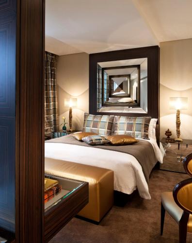 a bedroom with a large bed with a mirror at Mandarin Oriental Al Faisaliah, Riyadh in Riyadh