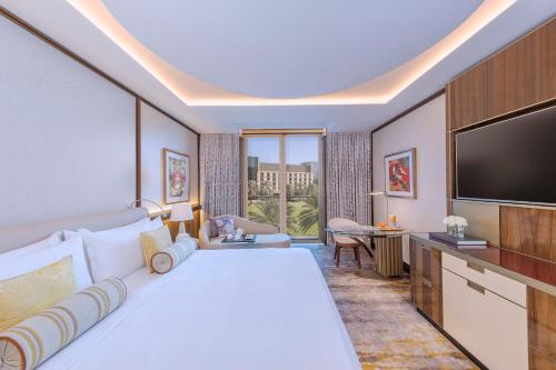 a hotel room with a large bed and a flat screen tv at Mandarin Oriental Al Faisaliah, Riyadh in Riyadh