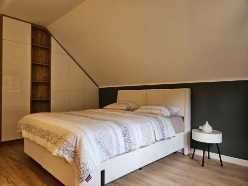 a bedroom with a large bed with a white bedspread at Forest Fox in Žabljak