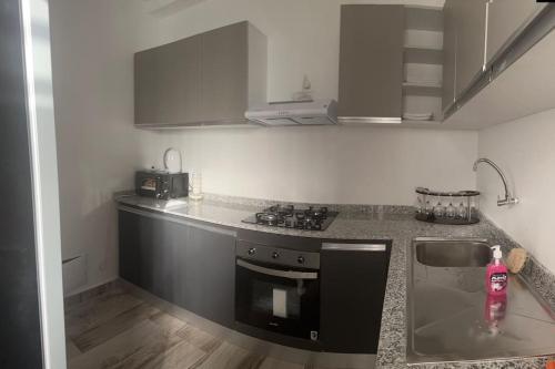 a kitchen with a sink and a stove top oven at BB immo dakar in Dakar