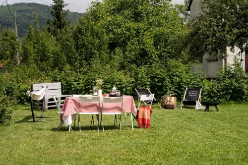 a table and chairs sitting in the grass at MiLove in Milówka