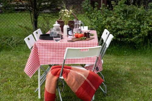 a picnic table with a red and white checkered table cloth at MiLove in Milówka