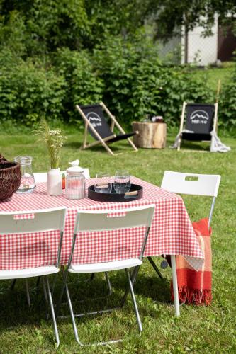 a picnic table with a red and white checkered table cloth at MiLove in Milówka