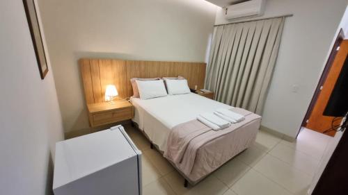 a small bedroom with a bed and a night stand at Italian Palace Hotel in Sinop