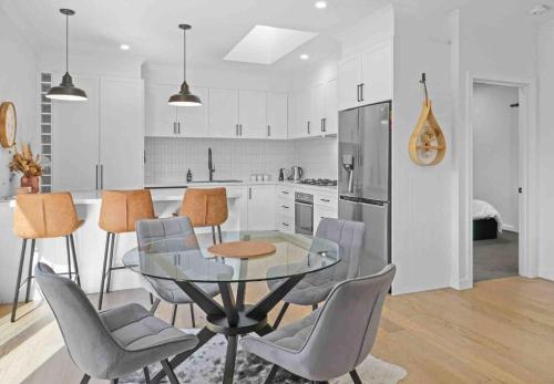 a kitchen with a glass table and some chairs at Ailsafield - Home in the heart of Mansfield in Mansfield