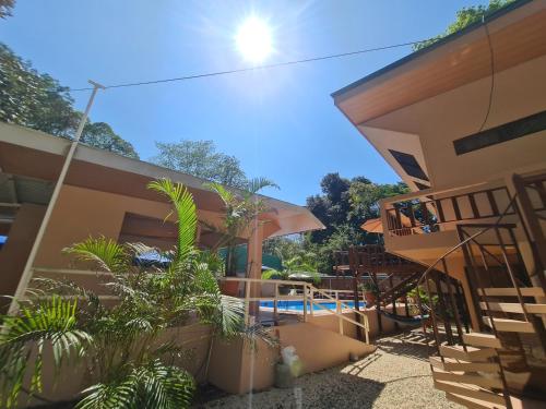 a house with a swimming pool and some plants at Cool Waters Jungle Villas in Uvita
