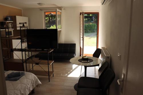 a living room with a television and a table at Apartments Matelici in Divšići