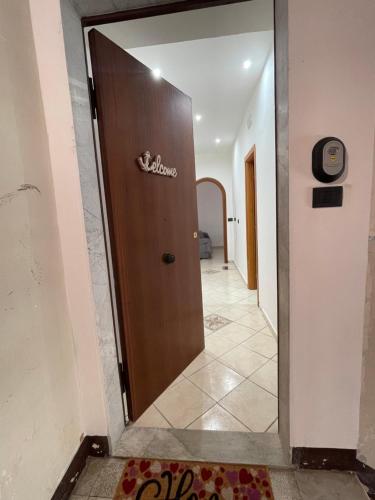 a door leading into a hallway with a sign on it at DATO House in Catania