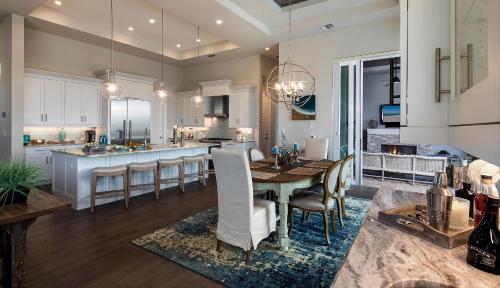 a kitchen and dining room with a table and chairs at Addison Opulence in Marco Island