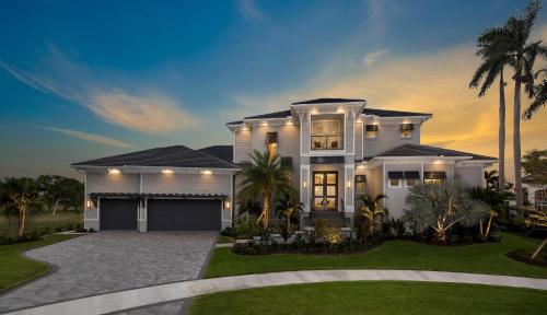 a large white house with a garage at Addison Opulence in Marco Island