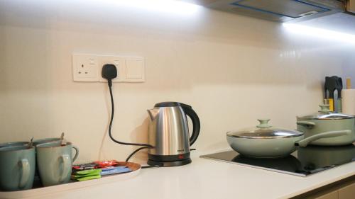 a kitchen counter with a coffee maker and a mixer at Eaton Residence KLCC - KL SUITE in Kuala Lumpur