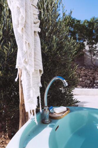 a bathroom sink with a towel hanging over it at House Of Omm in Sidi Kaouki