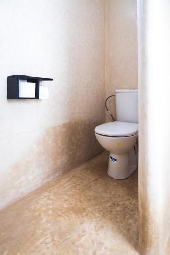 a bathroom with a toilet in a room at House Of Omm in Sidi Kaouki