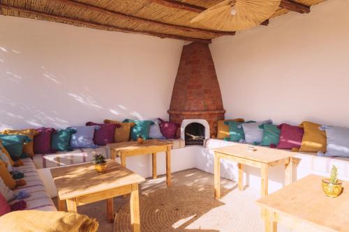 a living room with a couch and a fireplace at House Of Omm in Sidi Kaouki