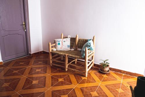 a room with a rocking chair and a door at House Of Omm in Sidi Kaouki